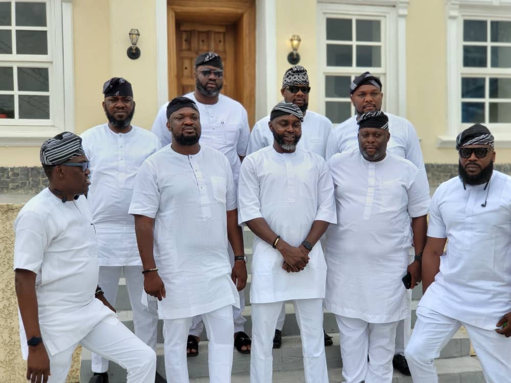 TBG members in matching white attire and traditional caps