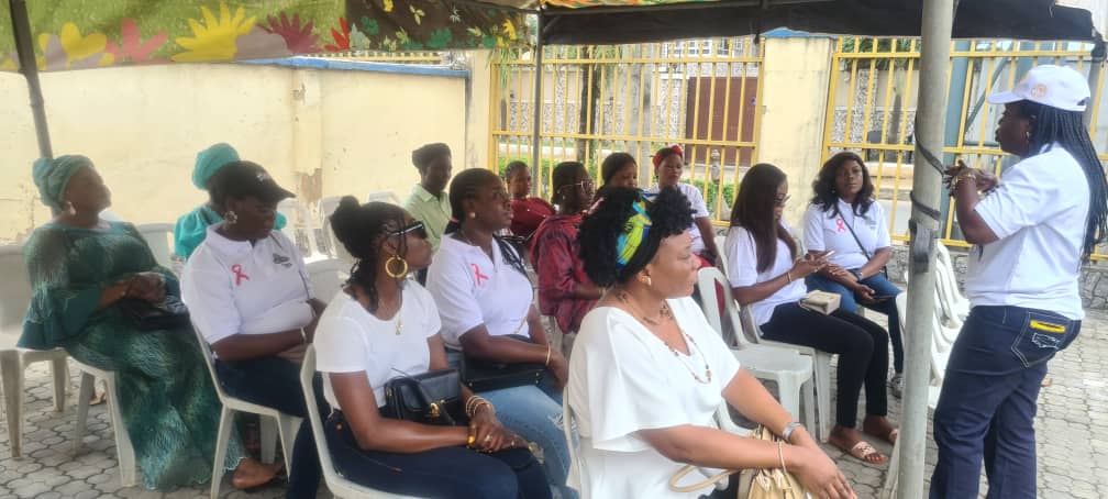 A health worker addressing women at the Kajola Foundation cervical cancer screening