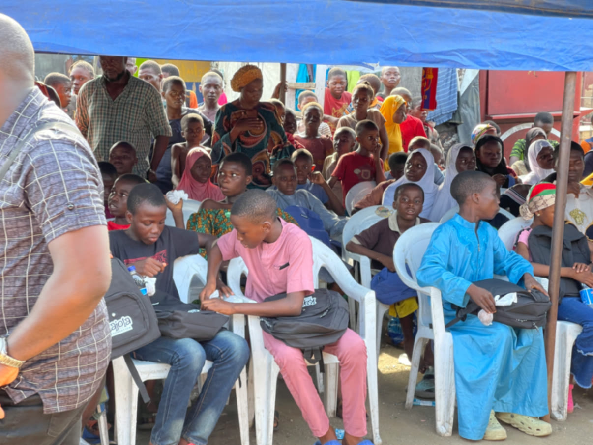 A large crowd of children and parents at a Kajola Foundation outreach