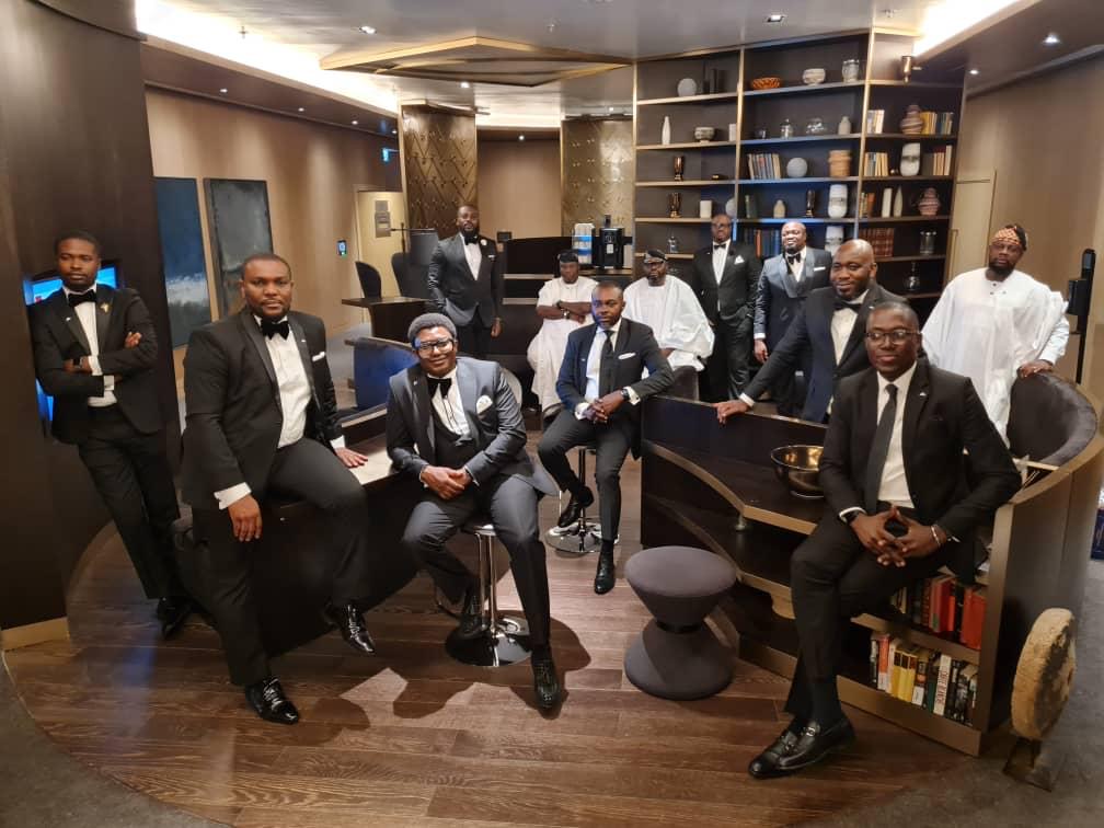 TBG members in black tie gathered in a lounge